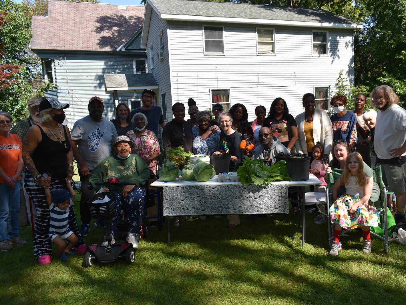A photograph of the garden members at their 25th year celebration of the 341 Midland Ave Community Garden.